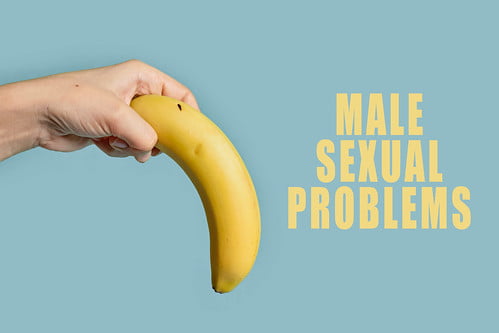 Woman hand holds banana tilted down, symbol of erectile dysfunction, male impotence or male sexual p