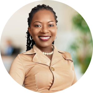 an black woman wearing a coffee brown dress and smiling